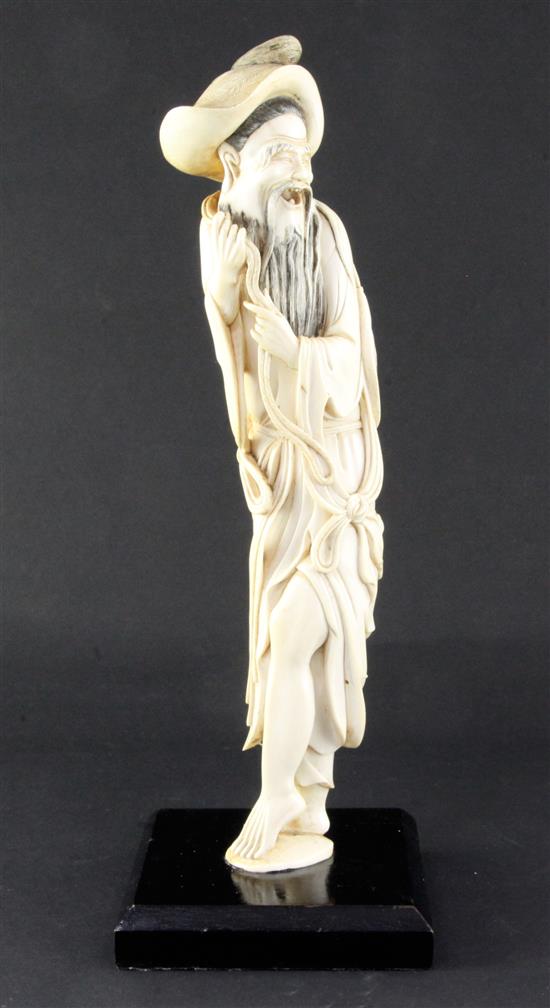 A tall Chinese ivory figure of a fisherman, early 20th century, 34.5cm excluding wood stand